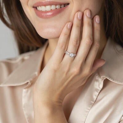 "Moving Forward Together" Round Cut Side Stone Engagement Ring