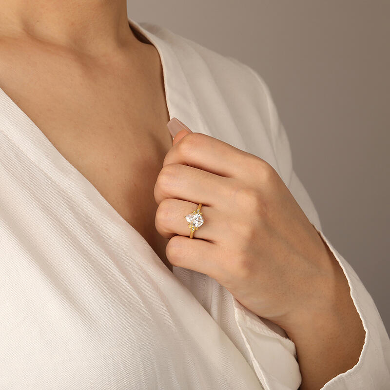 "Wings of Love" Pear Cut Side Stone Engagement Ring